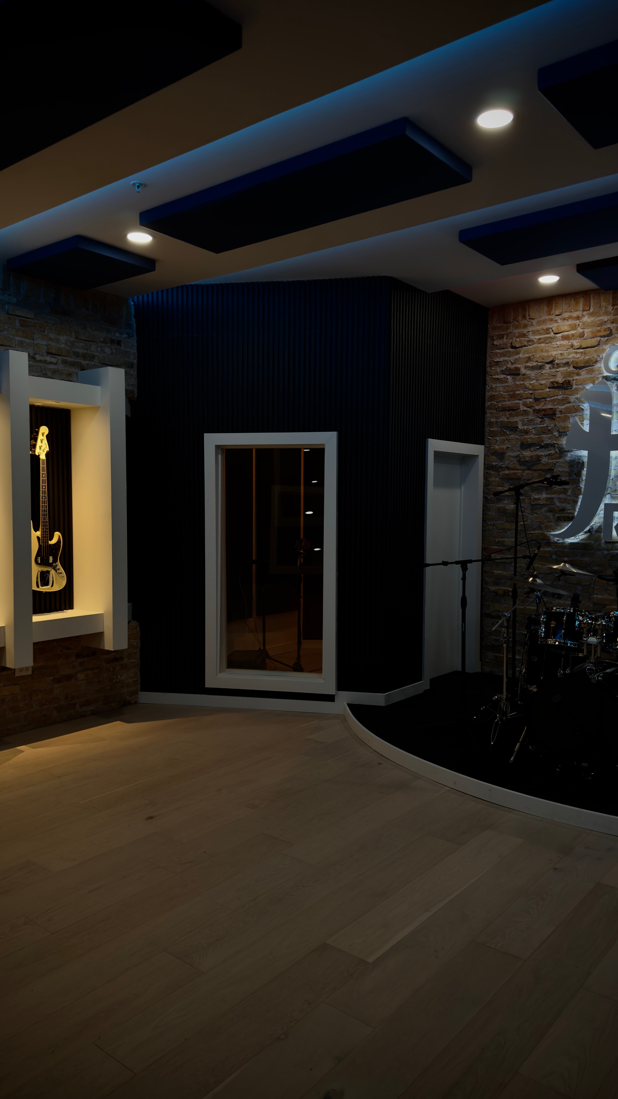 Live room with bass guitar on wall